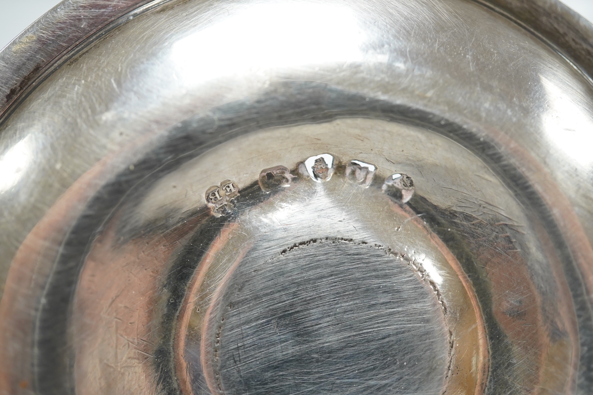 A George III miniature silver chamber stick, Emes & Barnard, London, 1815(a.f.), with matching extinguisher, base diameter 75mm. Condition - poor